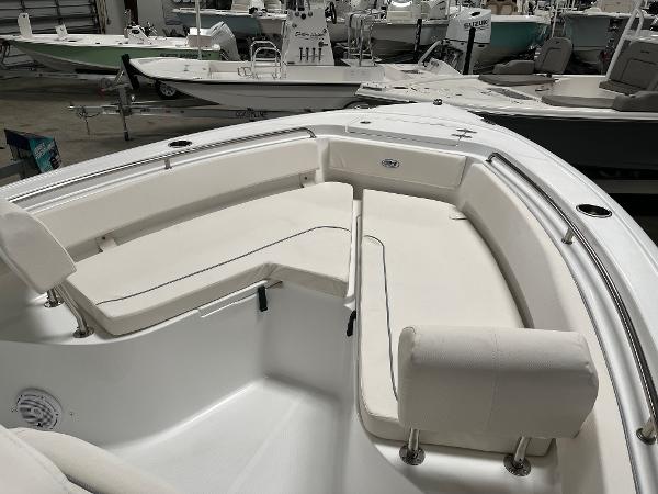 Slide: The Image of 2024 Sea Hunt Ultra 239 SE boat interior with white cushioned seating. - 23