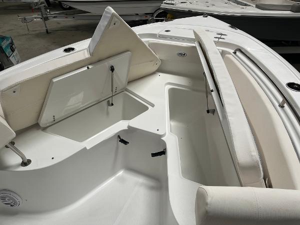 Slide: The Image of 2024 Sea Hunt Ultra 239 SE boat interior with open storage compartments. - 24
