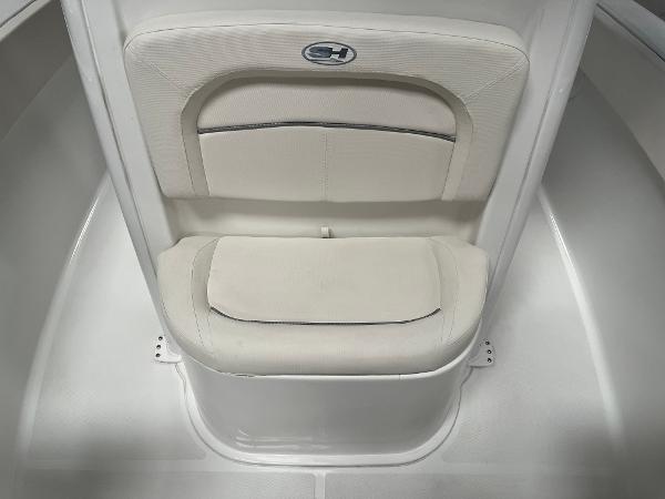 Slide: The Image of 2024 Sea Hunt Ultra 239 SE boat seat with white cushioned backrest. - 25