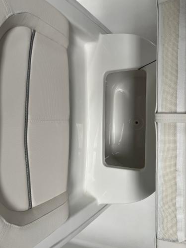 Slide: The Image of 2024 Sea Hunt Ultra 239 SE boat interior seating and storage compartment. - 26