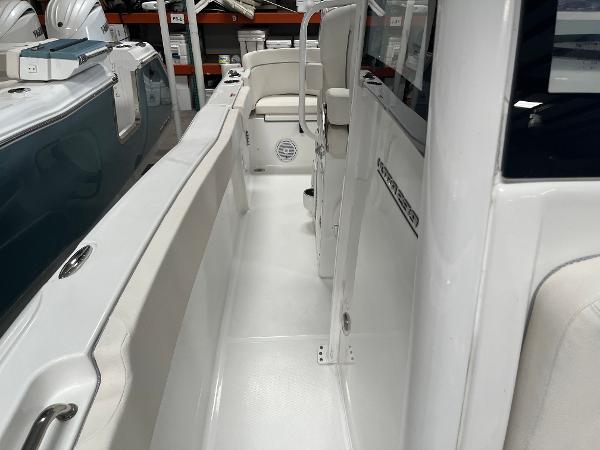 Slide: The Image of 2024 Sea Hunt Ultra 239 SE boat interior, white seating and clean deck. - 5