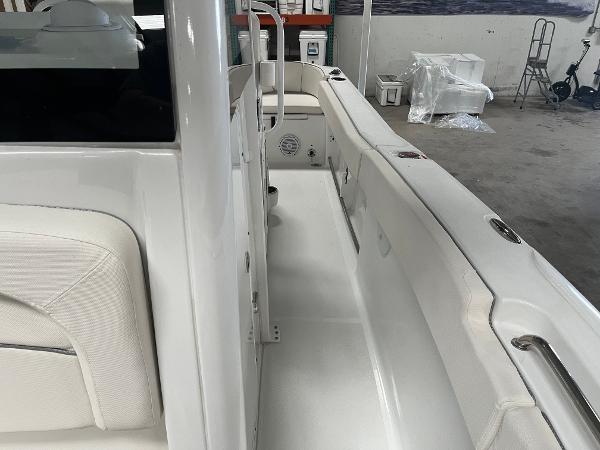 Slide: The Image of 2024 Sea Hunt Ultra 239 SE boat interior, white seating and clean deck. - 6