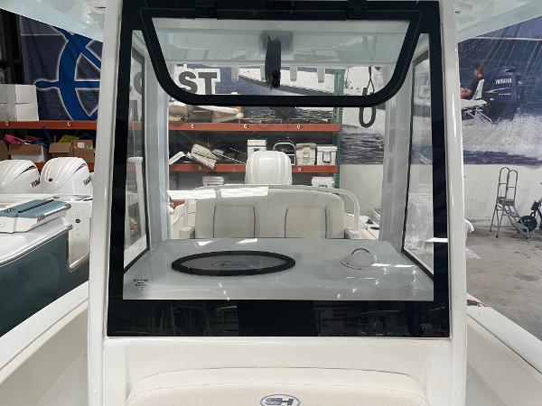 Slide: The Image of 2024 Sea Hunt Ultra 239 SE boat interior with white seating and console. - 7
