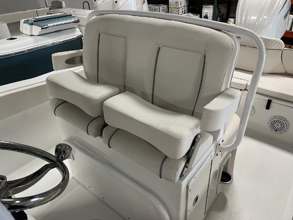 Slide: The Image of 2024 Sea Hunt Ultra 239 SE boat interior with dual cushioned seats. - 9