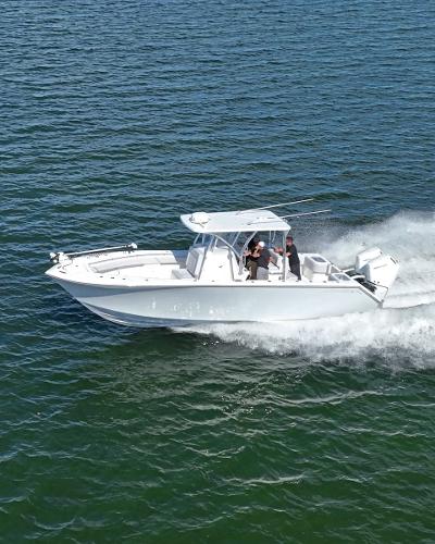 Slide: The Image of 2024 SeaHunter 31 boat cruising on open water. - 0