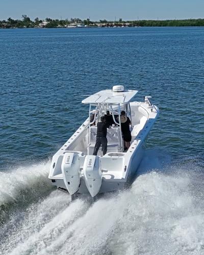 Slide: The Image of 2024 SeaHunter 31 boat cruising on open water with twin engines. - 4