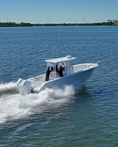 Slide: The Image of 2024 SeaHunter 31 boat cruising on a calm lake. - 5
