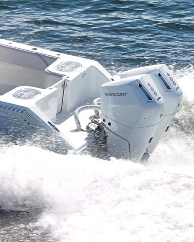 Slide: The Image of 2024 SeaHunter 31 boat with twin Mercury outboard engines on the water. - 6