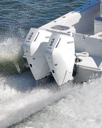Slide: The Image of 2024 SeaHunter 31 boat with twin Mercury 600 outboard engines on water. - 7