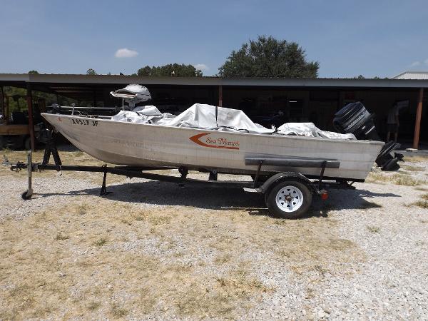Slide: The Image of 1978 Sea Nymph SS 160 boat on a trailer, covered and parked outdoors. - 0