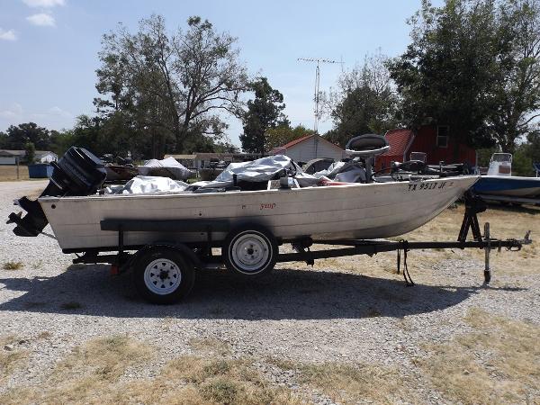 Slide: The Image of 1978 Sea Nymph SS 160 boat on a trailer in a yard. - 1