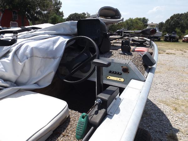 Slide: The Image of 1978 Sea Nymph SS 160 boat interior with steering wheel and controls, parked outdoors. - 6