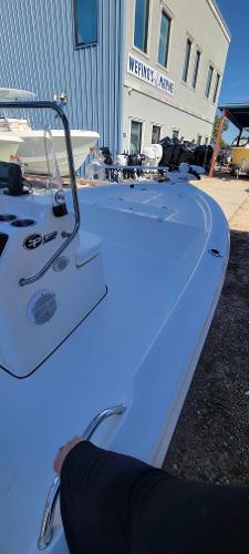 Slide: The Image of 2024 Sea Pro 172 Bay boat displayed at a marine dealership. - 13