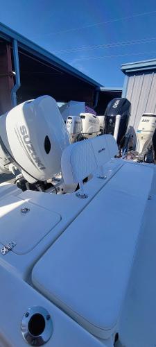Slide: The Image of 2024 Sea Pro 172 Bay boat with Suzuki outboard motor in a marina. - 14