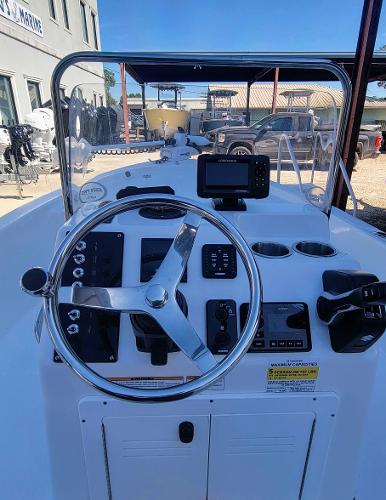 Slide: The Image of 2024 Sea Pro 172 Bay boat dashboard with steering wheel and navigation controls. - 5