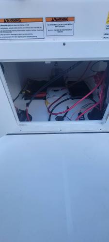 Slide: The Image of Battery compartment of a 2024 Sea Pro 172 Bay boat with visible wiring. - 8