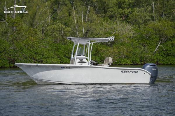 Slide: The Image of 2023 Sea Pro 219 Deep V CC boat on water with lush green background. - 0