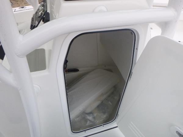 Slide: The Image of 2024 Sea Pro 222 Center Console storage compartment with open door. - 12