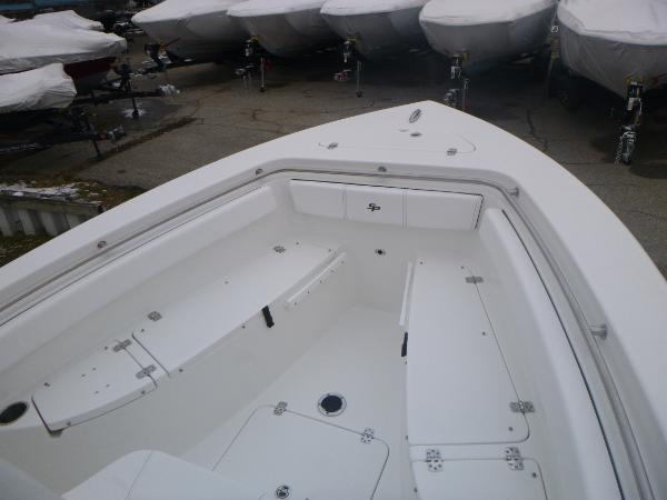 Slide: The Image of 2024 Sea Pro 222 Center Console boat interior, white seating and storage compartments. - 13