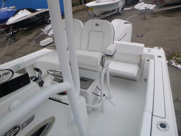 Slide: The Image of 2024 Sea Pro 222 Center Console boat interior with white seating and Mercury engine. - 15