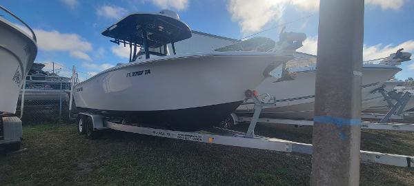 Slide: The Image of 2020 Sea Pro 239CC boat on a trailer in a yard. - 0