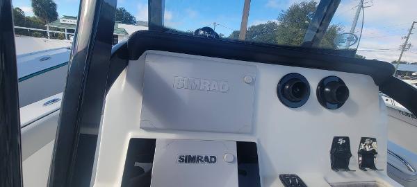 Slide: The Image of 2020 Sea Pro 239CC boat dashboard with Simrad electronics and controls. - 18