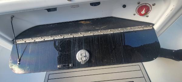Slide: The Image of 2020 Sea Pro 239CC boat storage compartment with latch and red control knob. - 20