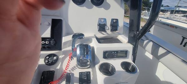 Slide: The Image of 2020 Sea Pro 239CC boat console with controls and cup holders. - 21