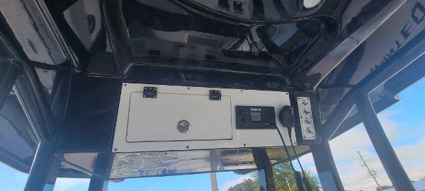 Slide: The Image of 2020 Sea Pro 239CC boat console with electronic controls and storage compartment. - 23