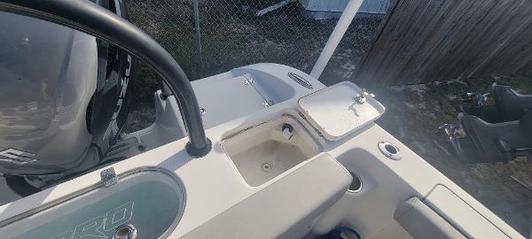 Slide: The Image of 2020 Sea Pro 239CC boat deck with storage compartments and motor. - 31