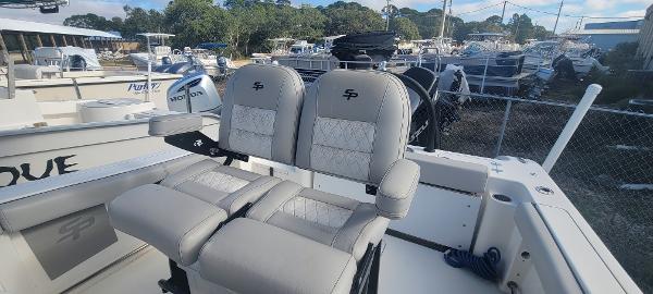 Slide: The Image of 2020 Sea Pro 239CC boat with dual captain's chairs in a marina. - 33