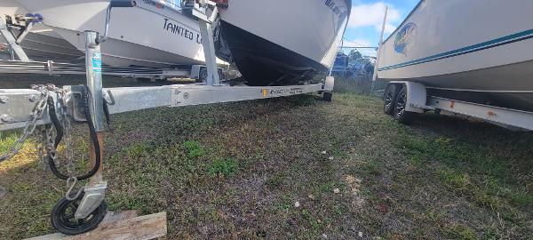 Slide: The Image of 2020 Sea Pro 239CC boat on a trailer, parked on grass. - 6