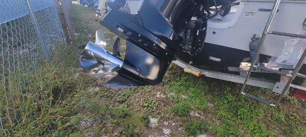 Slide: The Image of 2020 Sea Pro 239CC boat with outboard motor and propeller, parked on grass. - 8