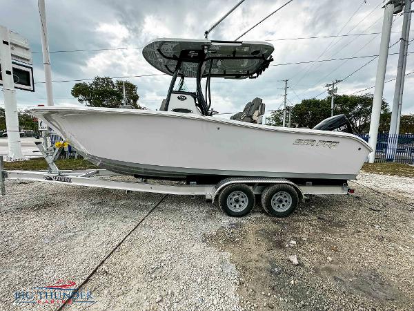 Slide: The Image of 2023 Sea Pro 239 DLX boat on a trailer, side view. - 1