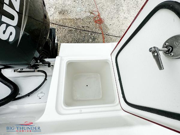 Slide: The Image of 2023 Sea Pro 239 DLX boat with Suzuki engine and storage compartment. - 20