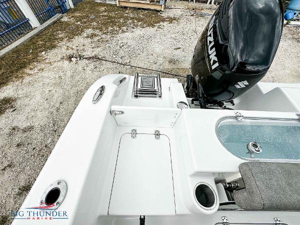 Slide: The Image of 2023 Sea Pro 239 DLX boat with Suzuki outboard motor, rear deck view. - 22