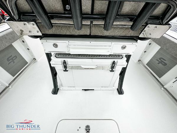 Slide: The Image of 2023 Sea Pro 239 DLX boat interior with storage and seating, Big Thunder Marine logo. - 24