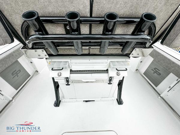 Slide: The Image of 2023 Sea Pro 239 DLX boat interior with rod holders and storage compartments. - 25