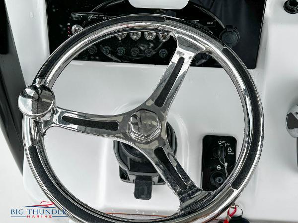 Slide: The Image of 2023 Sea Pro 239 DLX boat steering wheel and control panel. - 34