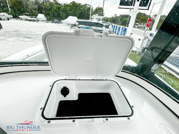Slide: The Image of 2023 Sea Pro 239 DLX boat storage compartment with open lid at Big Thunder Marine. - 36