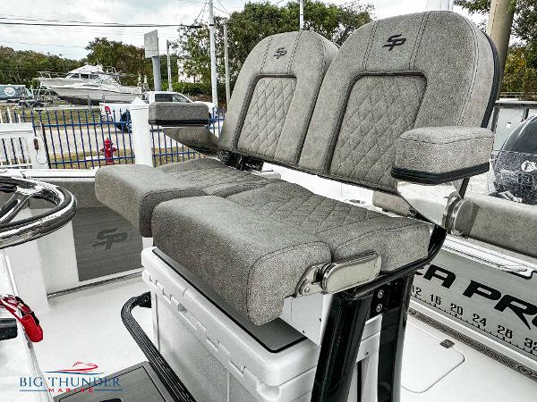 Slide: The Image of 2023 Sea Pro 239 DLX boat with dual cushioned seats and storage compartment. - 37