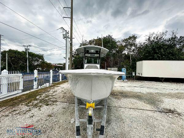 Slide: The Image of 2023 Sea Pro 239 DLX boat on trailer, front view, outdoor setting. - 4
