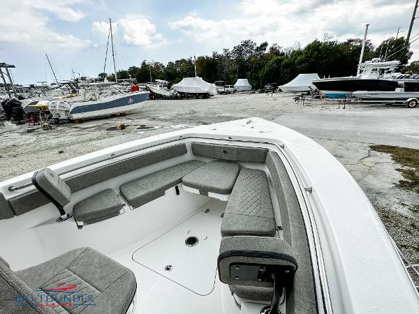 Slide: The Image of 2023 Sea Pro 239 DLX boat with spacious seating in a marina. - 40