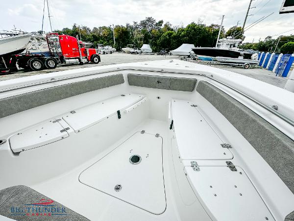 Slide: The Image of 2023 Sea Pro 239 DLX boat interior with ample storage and seating. - 45