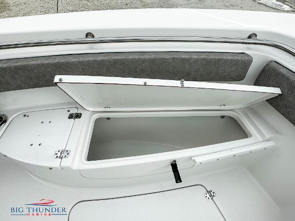 Slide: The Image of 2023 Sea Pro 239 DLX boat storage compartment open, displayed by Big Thunder Marine. - 46