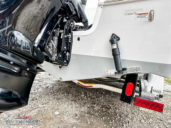 Slide: The Image of 2023 Sea Pro 239 DLX boat rear view with motor and trailer. - 8