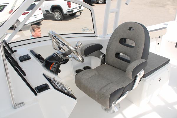 Slide: The Image of 2024 Sea Pro 240 boat helm with captain's chair and steering wheel. - 15