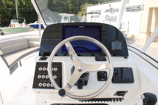 Slide: The Image of 2024 Sea Pro 240 boat dashboard with steering wheel and electronic controls. - 17