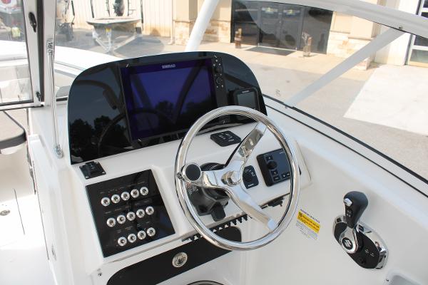 Slide: The Image of 2024 Sea Pro 240 boat dashboard with steering wheel and control panel. - 4