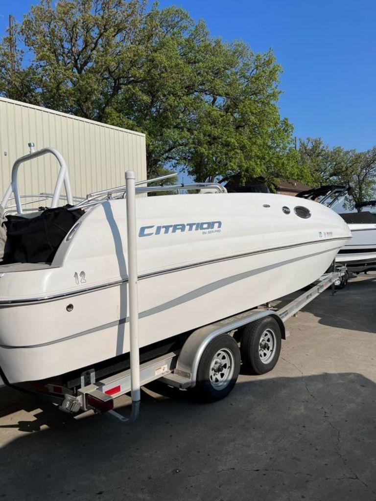 Slide: The Image of 2022 Sea Pro Citation 2400 boat on a trailer, parked outdoors. - 0